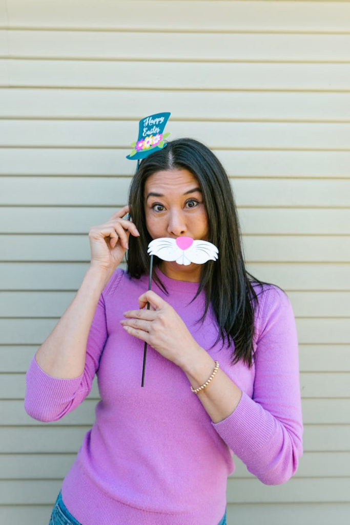 Woman posing with fun Easter bunny props indoors.